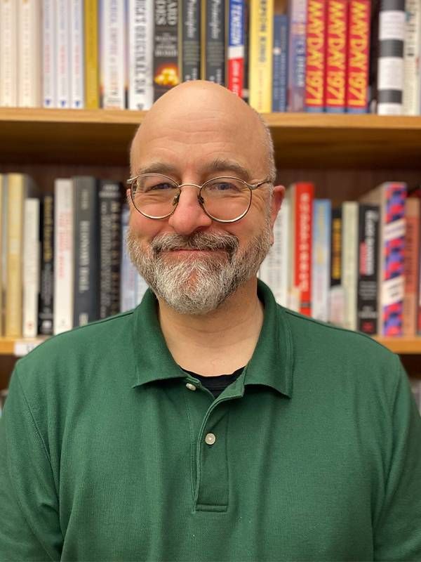 A man wearing green smiling in a bookstore. Next Avenue, celebrity memoirs