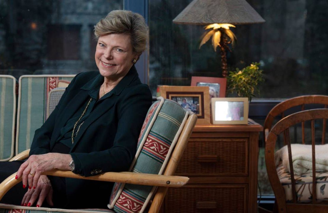 Cokie Roberts sitting in an arm chair at her home. Next Avenue
