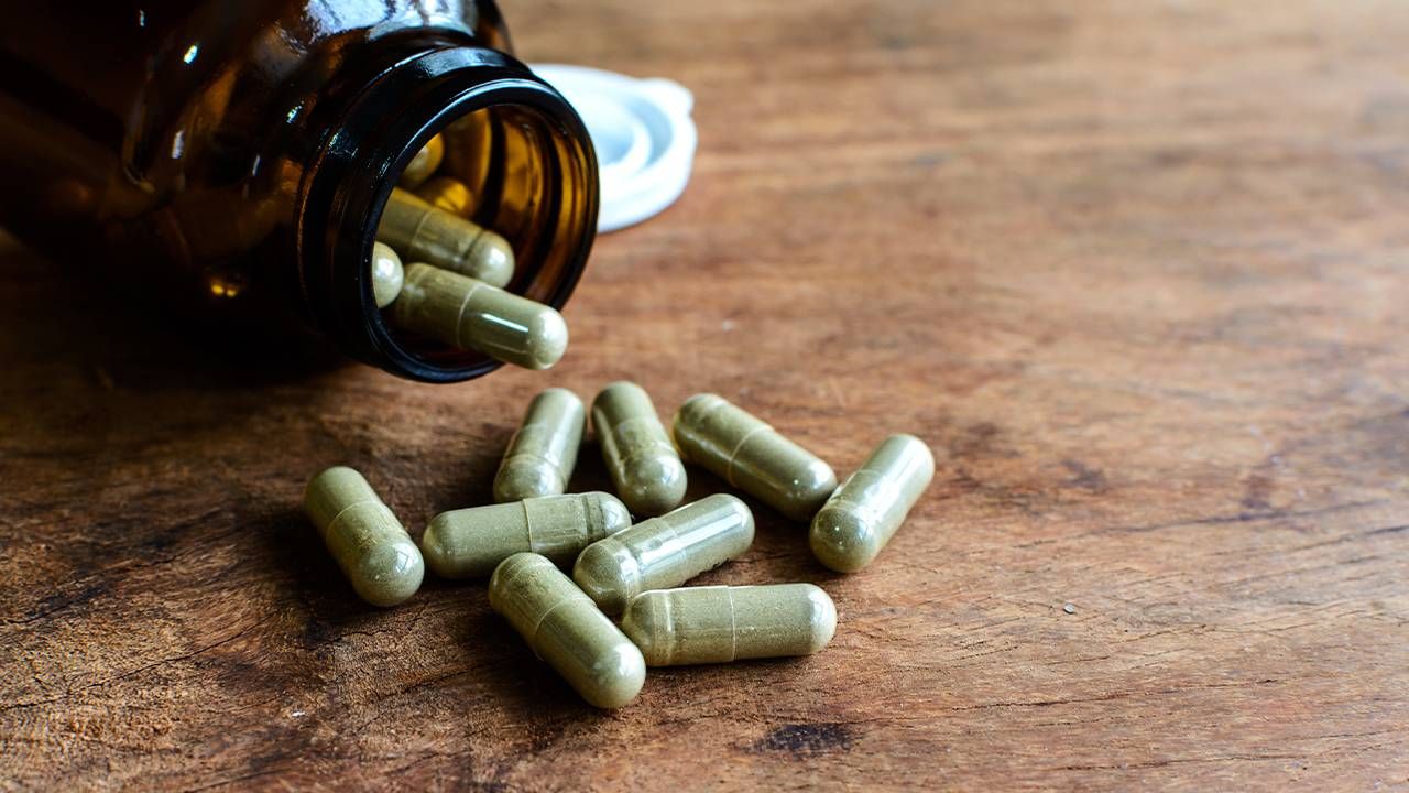 A pill bottle with vitamins spilled out onto a table. Next Avenue, nontraditional common cold treatments