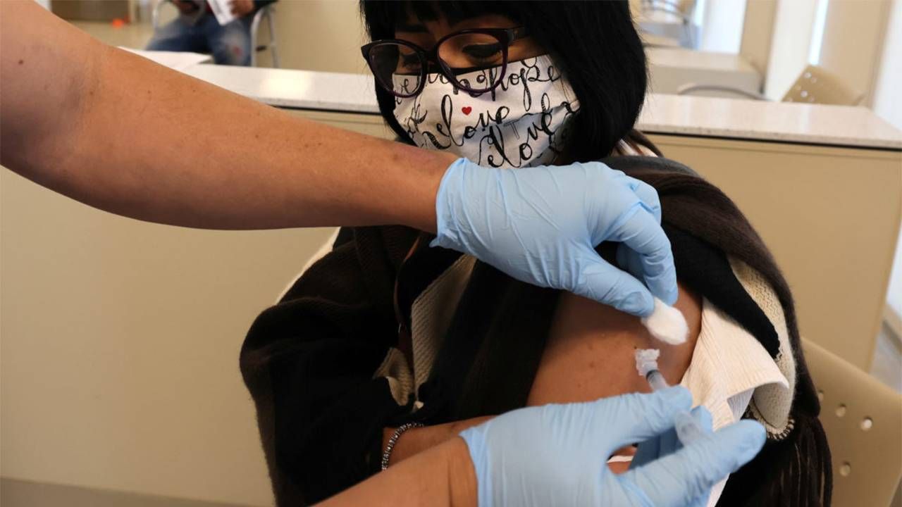 A hospital working giving a patient the flu vaccine. Next Avenue, protect from the flu