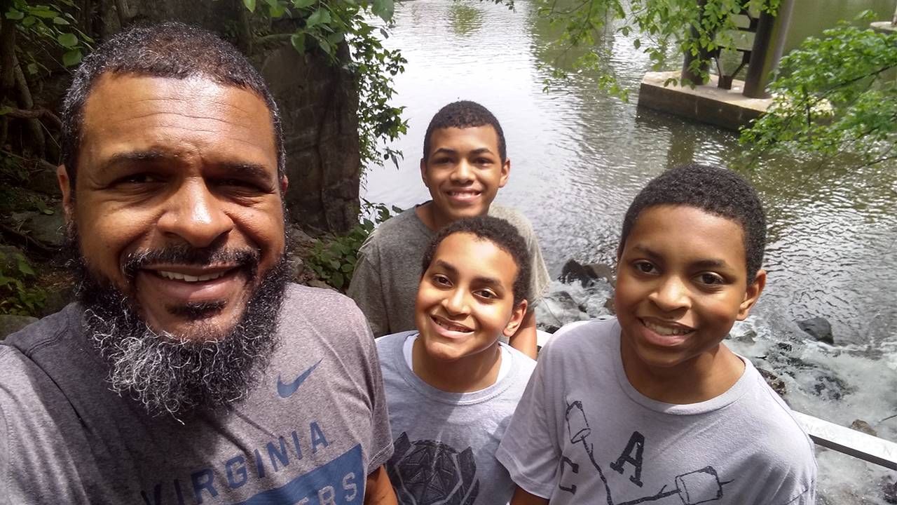 A parent and their 3 kids smiling after hiking outside. Next Avenue, financial advice parents teens