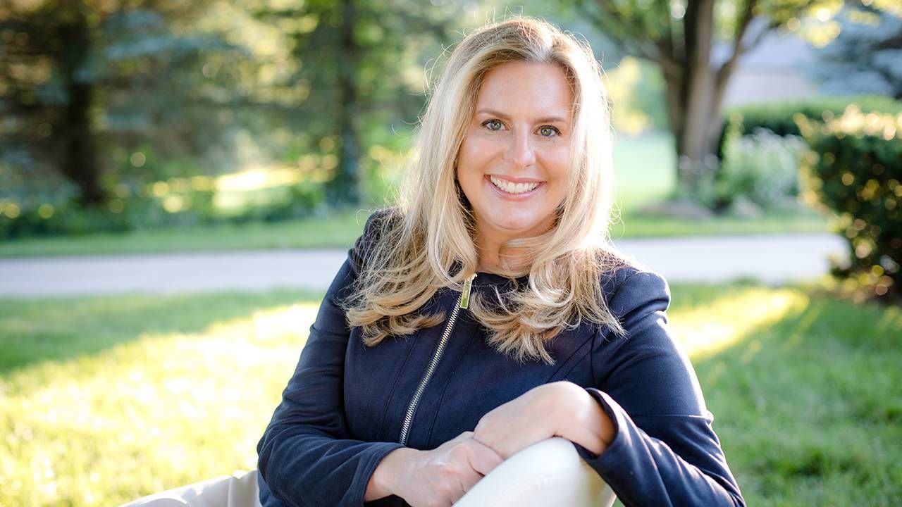 A woman sitting outside on a bench smiling. Next Avenue, Taxes, charity