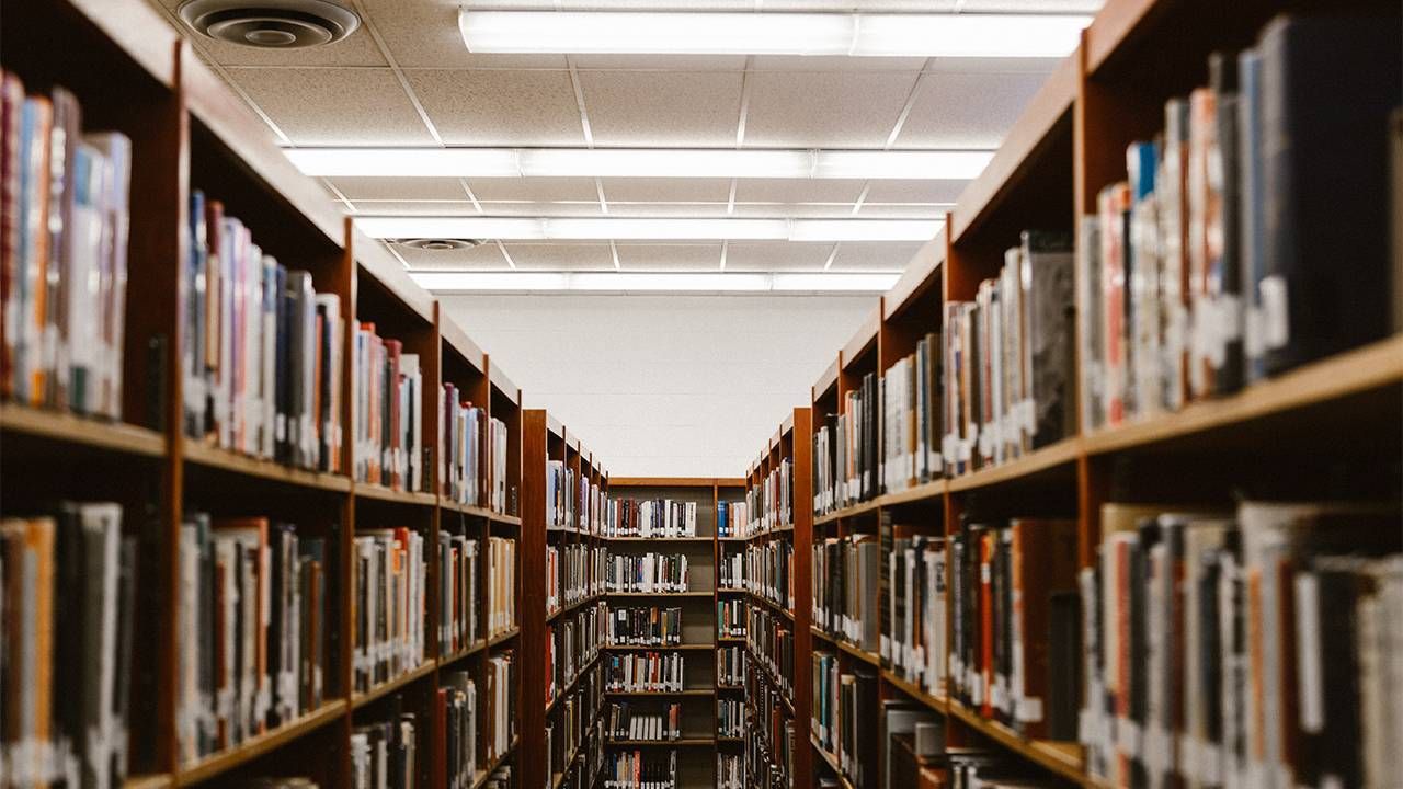 A vintage looking high school library aisle. Next Avenue