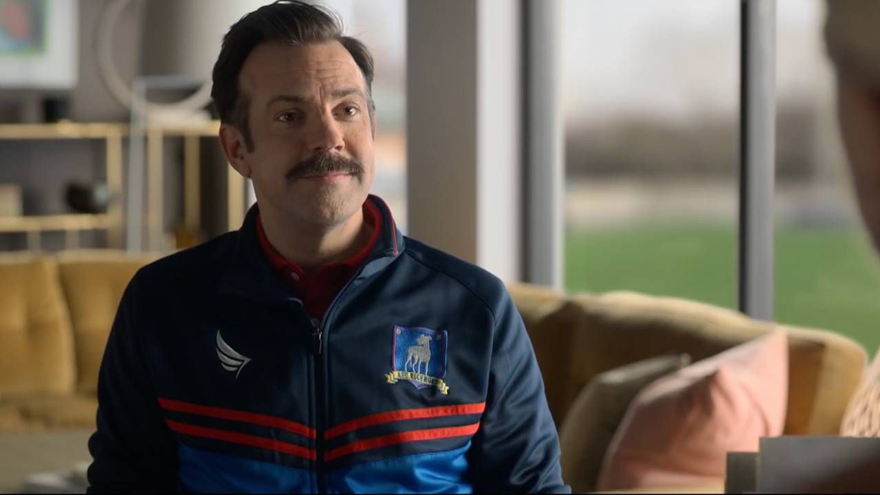 A still from Ted Lasso, the actor is smiling wearing his coaching gear. Next Avenue, kindness