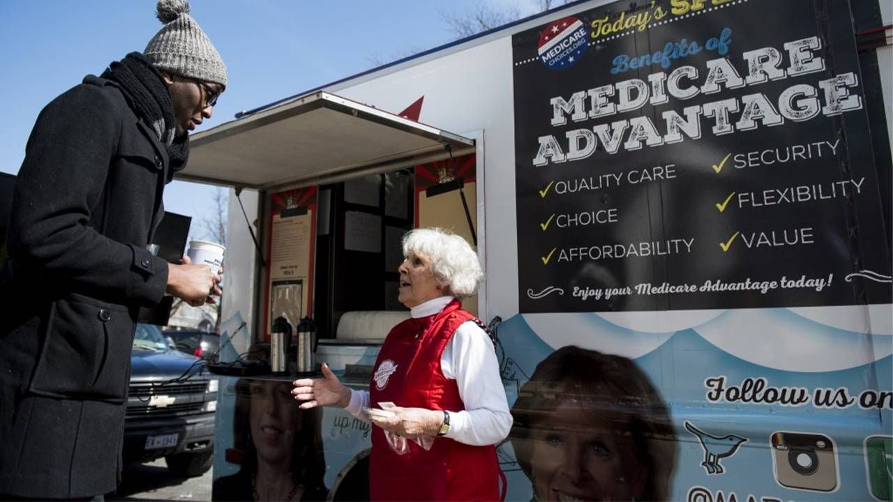 A person selling Medicare Advantage Plan outside. Next Avenue