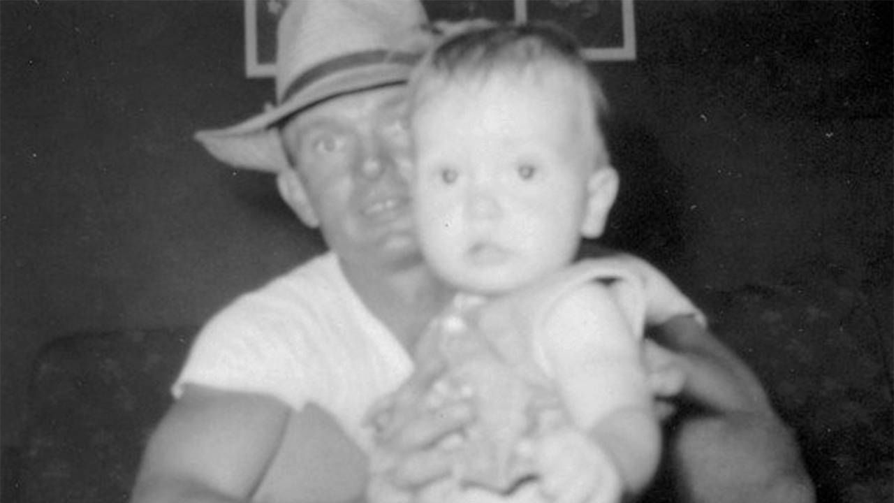 A man wearng a hat holding a baby. veteran, brother, Next Avenue