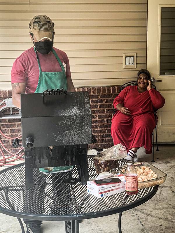 Two people sitting outside grilling on the barbeque. Next Avenue, pandemic change nursing homes