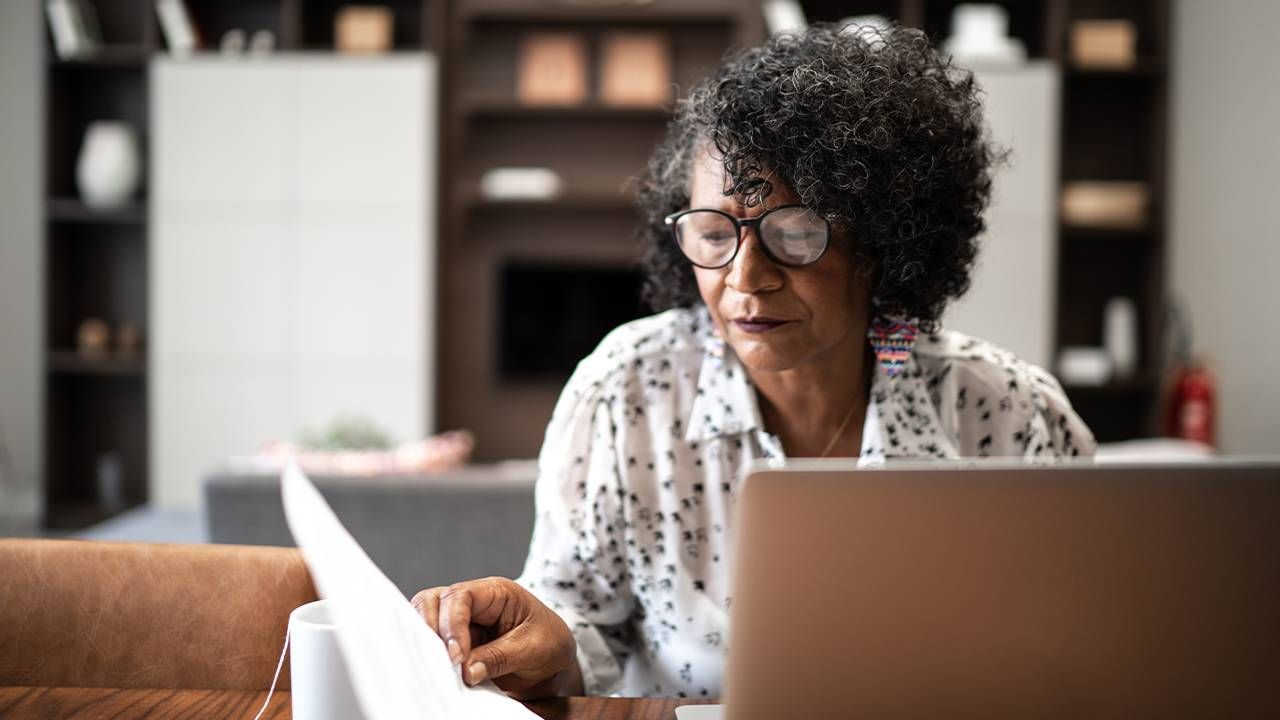 A woman working from home on her laptop, experiencing unconscious ageism at work. Next Avenue, age bias