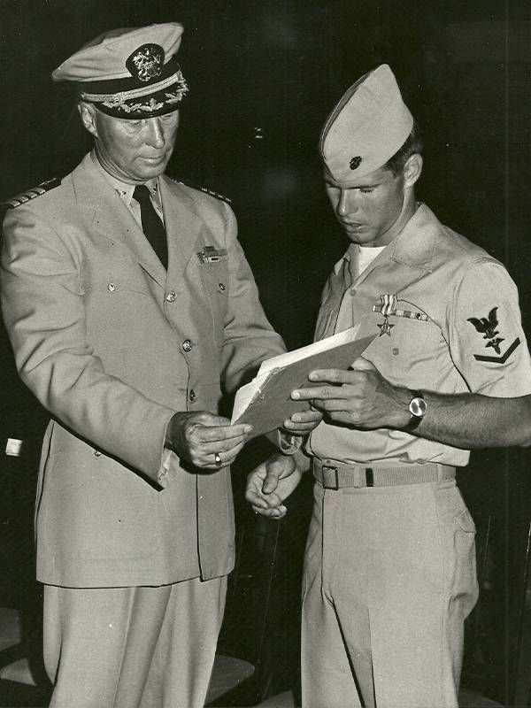 An old photo of two soldiers in uniform holding up a clip board. Veteran encore career, Next Avenue