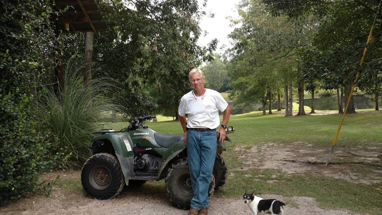 A man standing outside next to a four wheeler and his dog. veteran encore career, Next Avenue