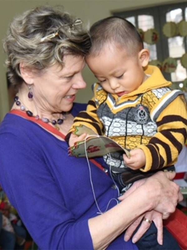 Cokie Roberts holding a young child. Next Avenue