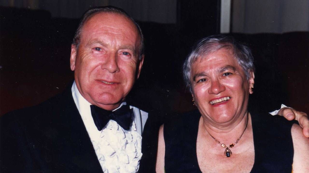 A couple smiling, dressed up in black tie event clothing. Next Avenue, ageism doctors nurses