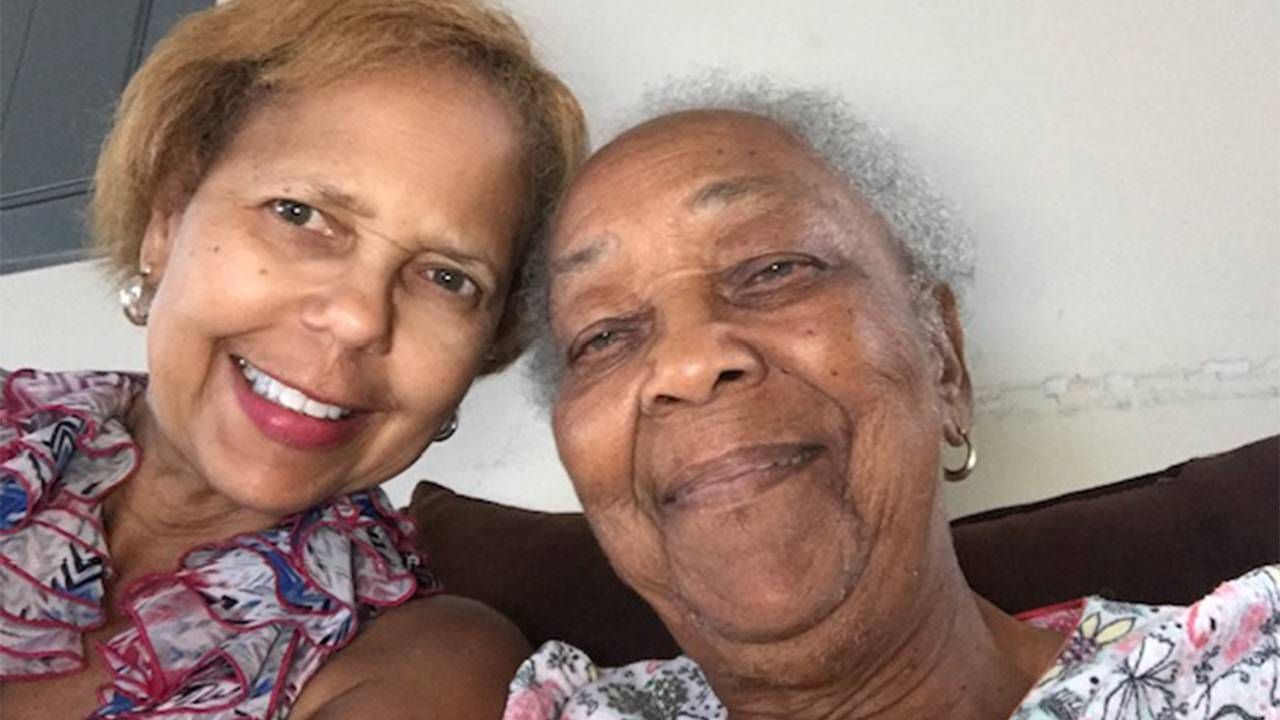 A mother and daughter sitting down together and smiling. Nect Avenue, caregiving, climate change