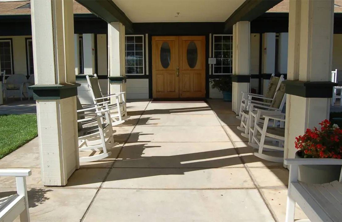 The entrance to an assisted living facility with heavy shadows. Next Avenue, assisted living facilities