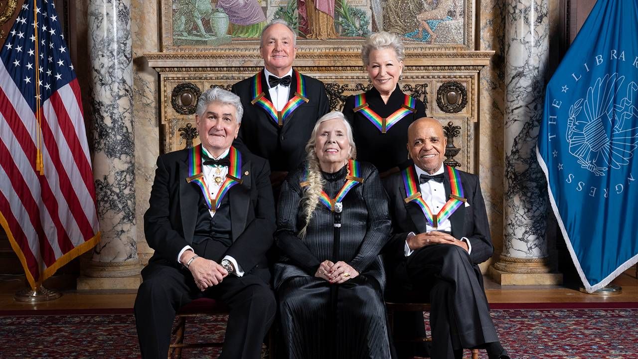 A group of people wearing black tie event clothing and medals with rainbow ribbon smiling. Next Avenue, Berry Gordy, Motown