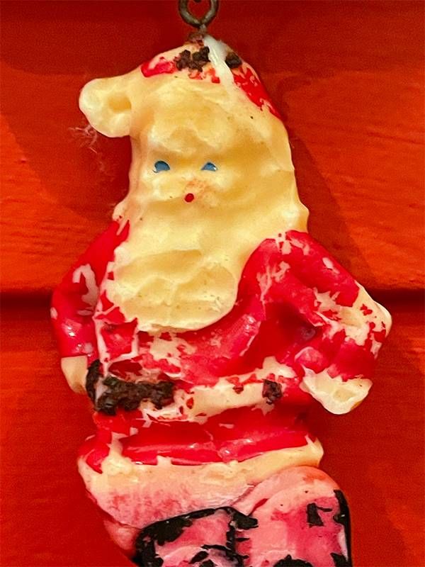 A closeup of a santa claus christmas ornament made out of wax. Next Avenue, christmas ornaments memories