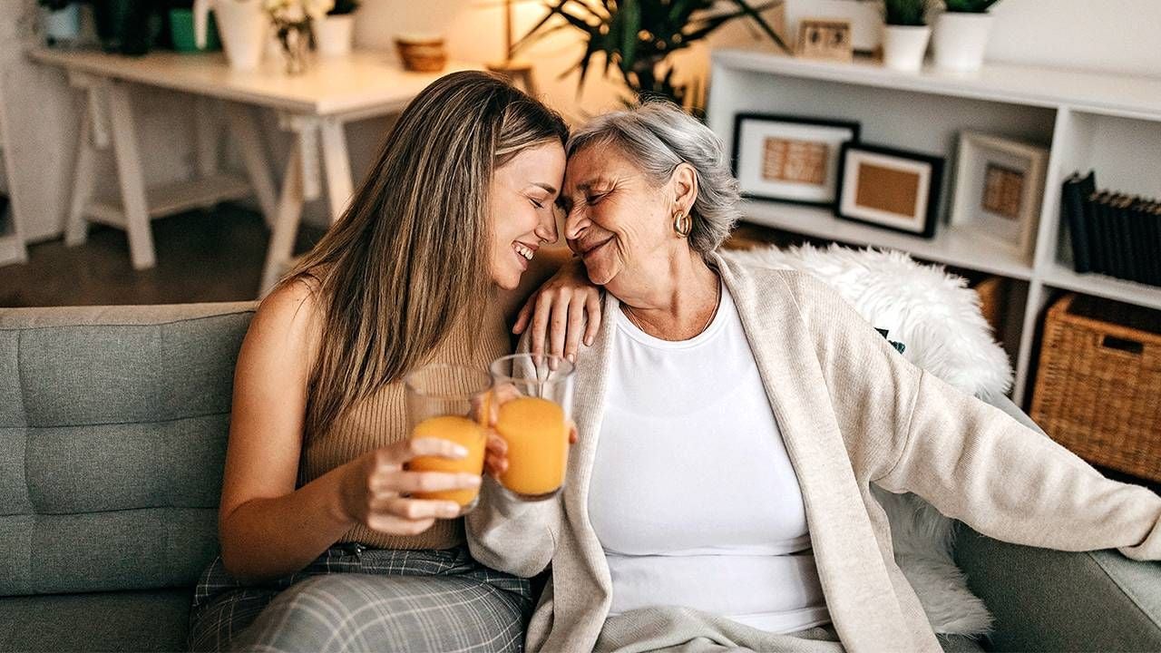 A daughter and her older mother touching foreheads and laughing. Next Avenue, older parents