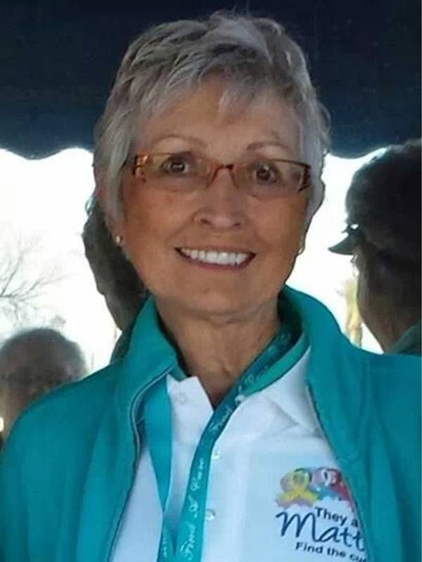 A woman wearing a teal jacket and glasses smiling. Next Avenue, women, clinical trials