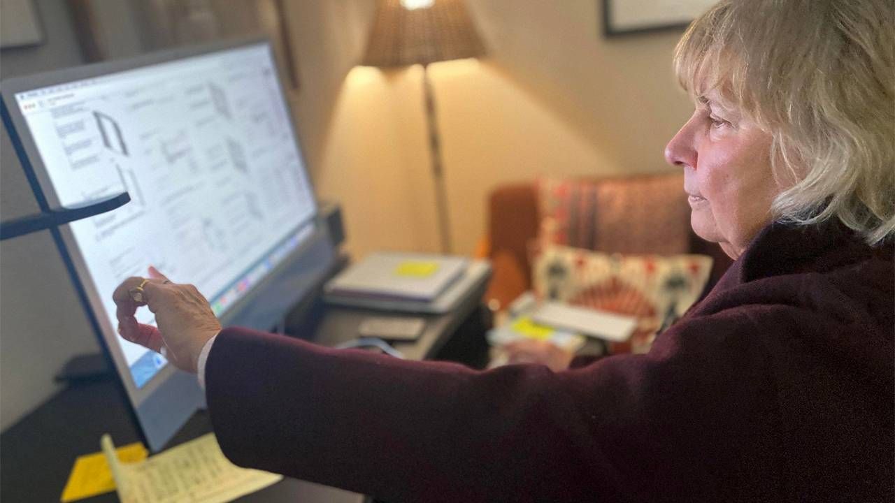 A woman working on her home computer. Next Avenue, retirement dementia