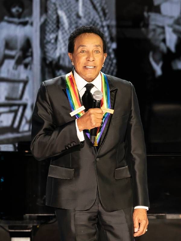 Smokey Robinson on stage wearing a medal during the Kennedy Center Honors. Next Avenue, Motown
