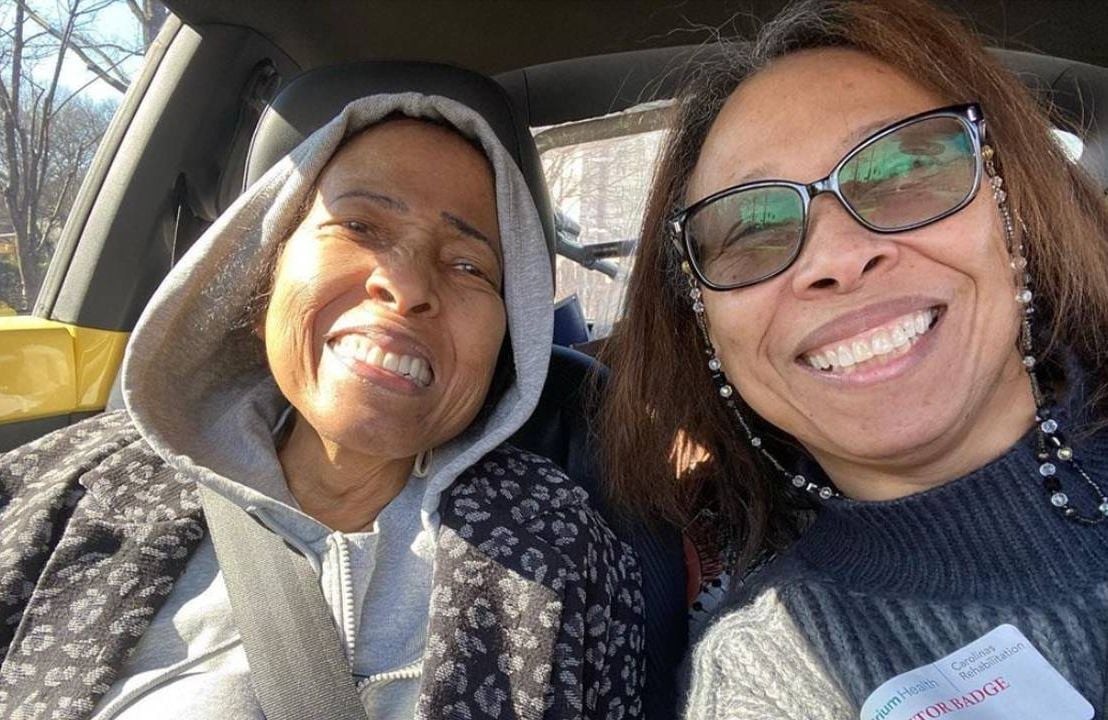 Two women smiling while sitting in a car. Next Avenue, Black women's hair