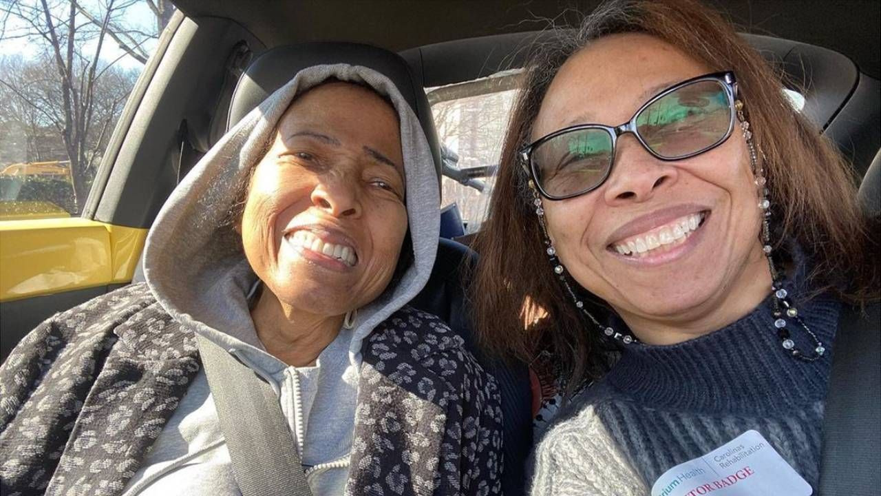 Two women smiling while sitting in a car. Next Avenue, Black women's hair