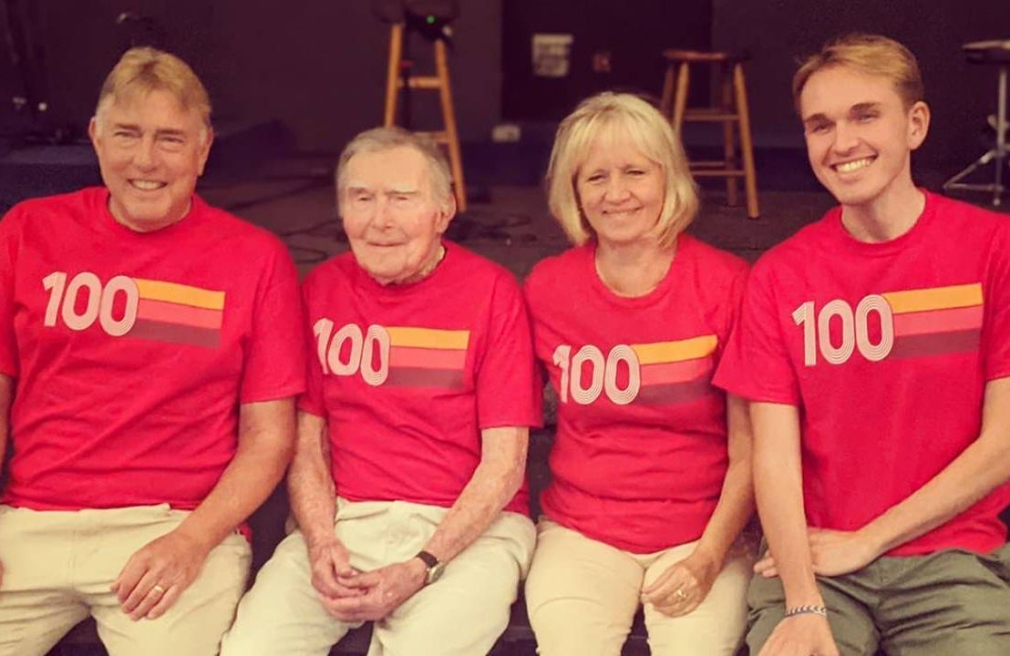 Four members of a family wearing matching shirts sitting side-by-side. Next Avenue, Century Lives podcast