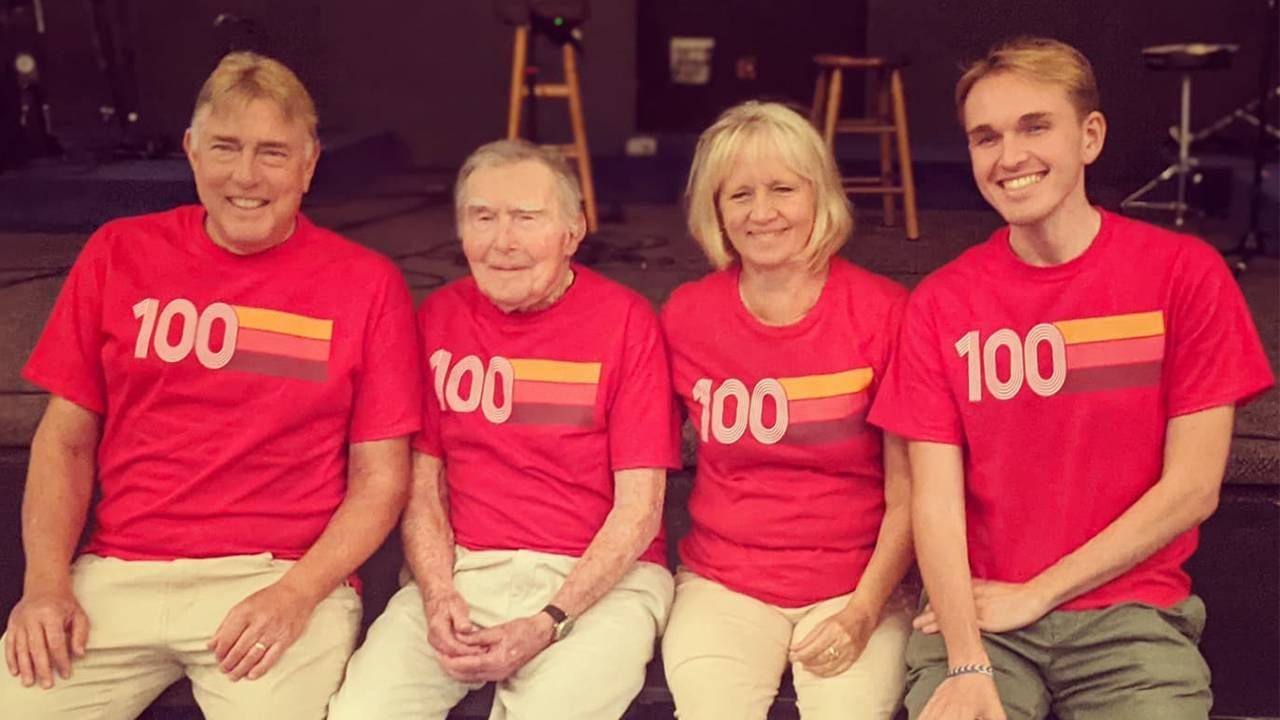 Four members of a family wearing matching shirts sitting side-by-side. Next Avenue, Century Lives podcast