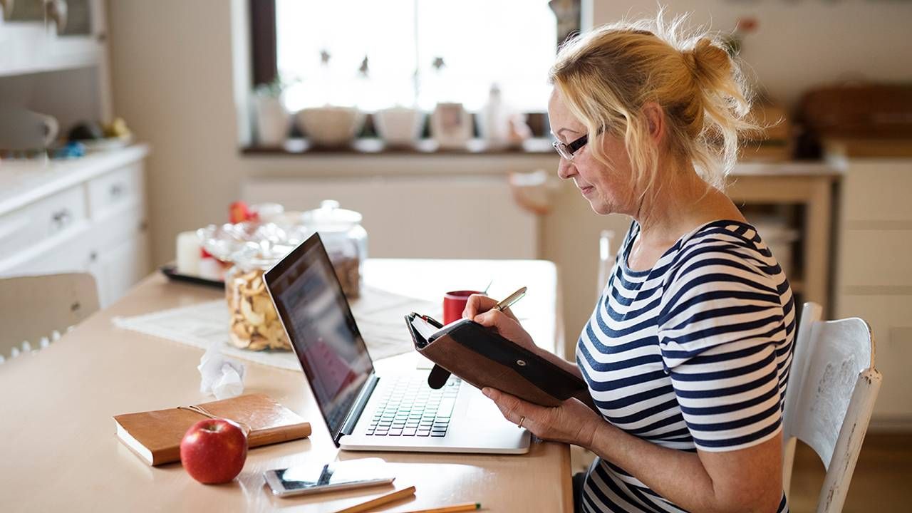 An older woman writing in her calendar so that she doesn't forget. Next Avenue, short term memory, forgetting, forgetfulness