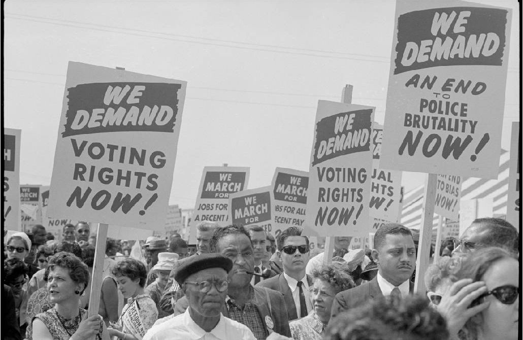 A black and white photograph of demonstrators holding up protest signs during the march on washington. Next Avenue, Black led social movements, ageism,