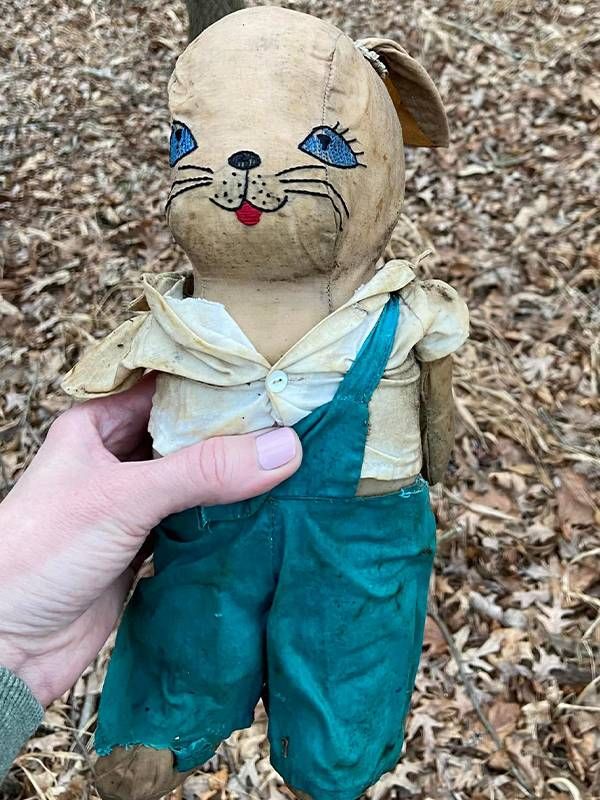 A tattered looking doll for a child held outside. Next Avenue, kentucky tornado belongings