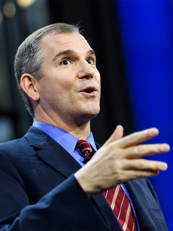 A older adult wearing a suit and tie while speaking on a stage. Next Avenue, Frank Bruni, The Beauty of Dusk