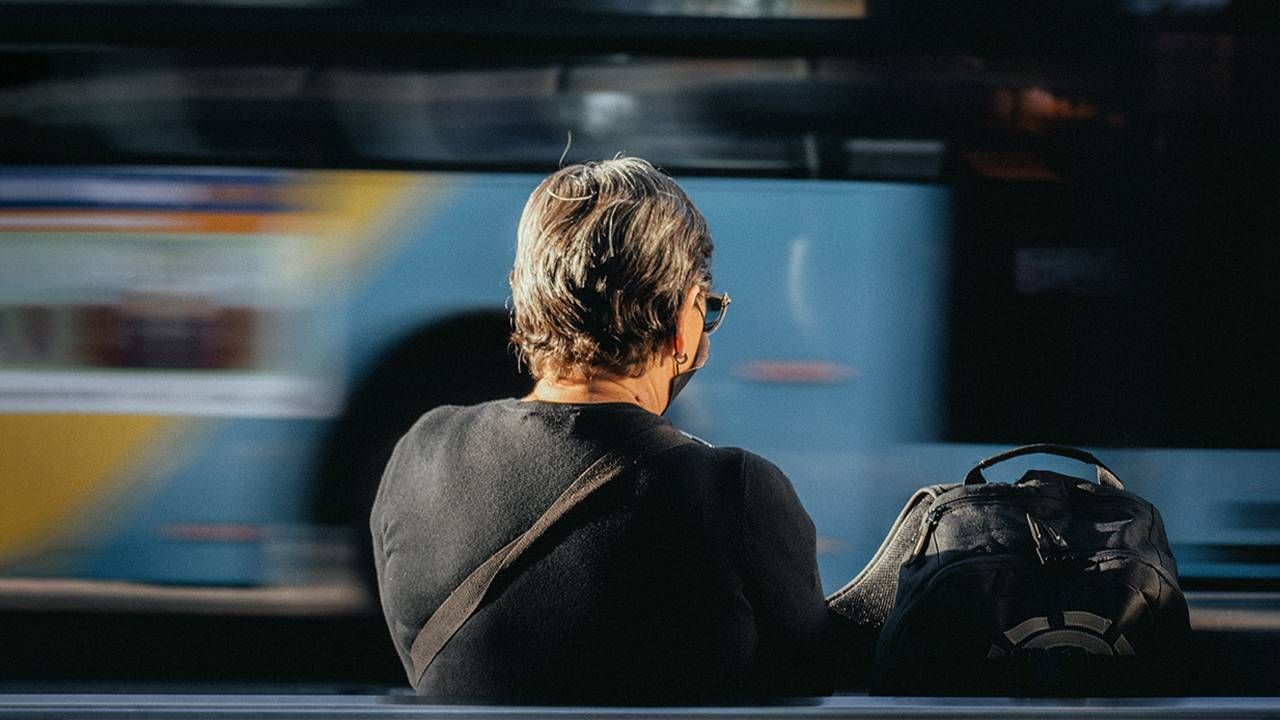 An older woman waiting at a bus stop during the COVID-19 pandemic. Next Avenue, covid impacts, competence, confidence