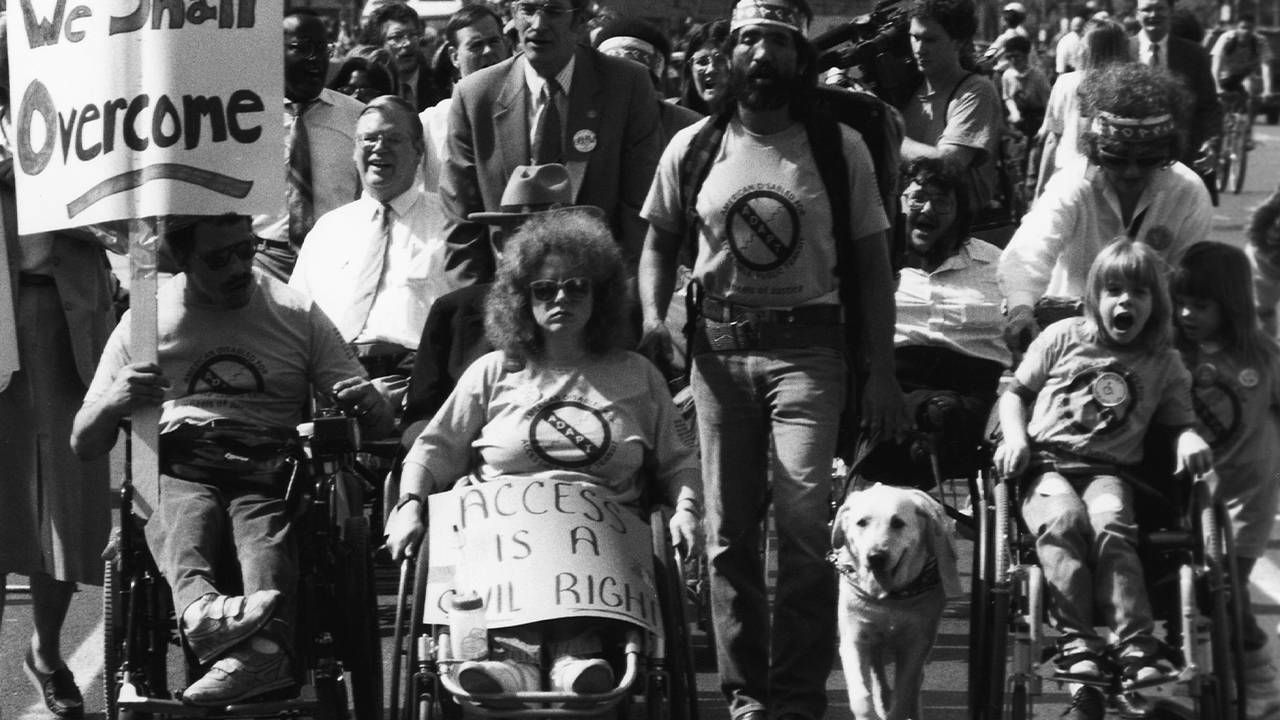 A group of activists during a protest march for the americans with disability act. Next Avenue, disability rights movement