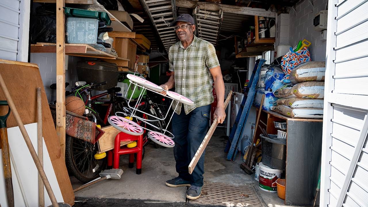 An older man organizing his shed and taking items to be donated. Next Avenue, downsizing, stuff
