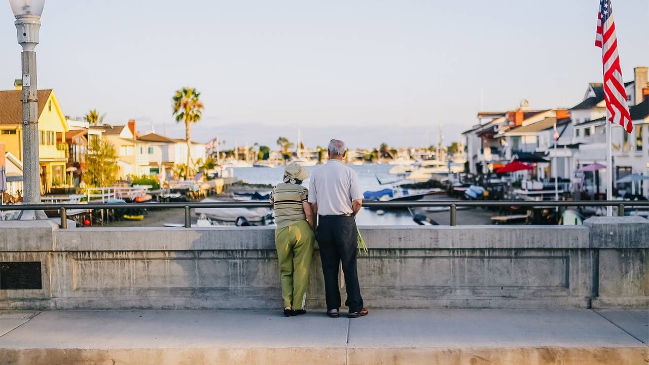 An older couple looking out at a canal. Next Avenue, mental health benefits