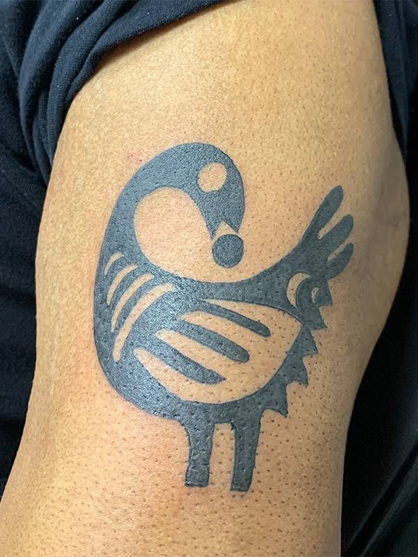 A close up of the writer's upper arm tattoo, a black tattoo of a bird. Next Avenue, first tattoo, tattoos older adults