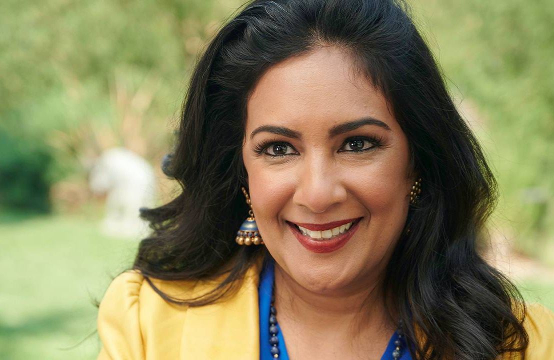 A woman wearing a yellow blazer and a bright blue shirt underneath. Next Avenue, women of color corporate america, "The First, The Few, The Only" Deepa Purushothaman