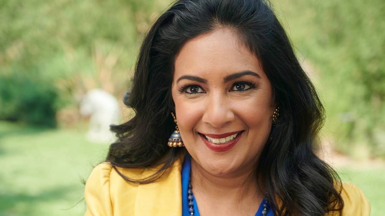 A woman wearing a yellow blazer and a bright blue shirt underneath. Next Avenue, women of color corporate america, "The First, The Few, The Only" Deepa Purushothaman