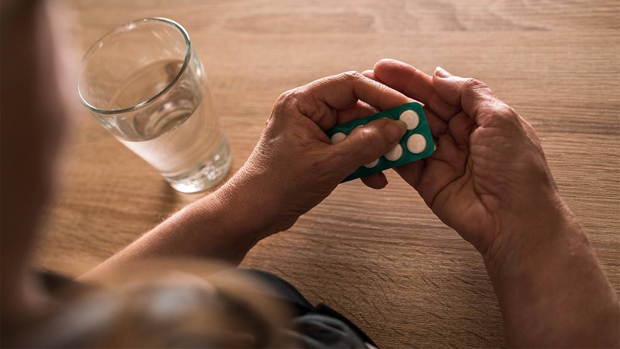 An older adult taking medication as a part of a clinical trial. Next Avenue, patient experience clinical trials