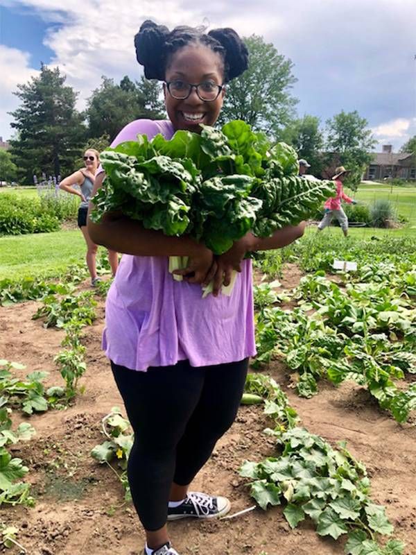 A gardening volunteer holding a bounty of lettuce from a garden. Next Avenue, Gardening exercise