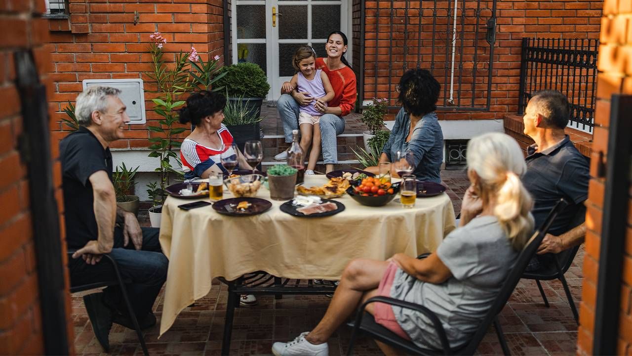 Family and Friends enjoying a dinner at home together. Next Avenue, inflation retirees fixed income