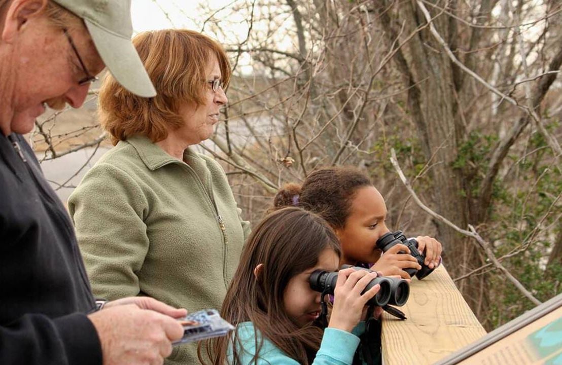 A family looking at nature with binoculars. Next Avenue