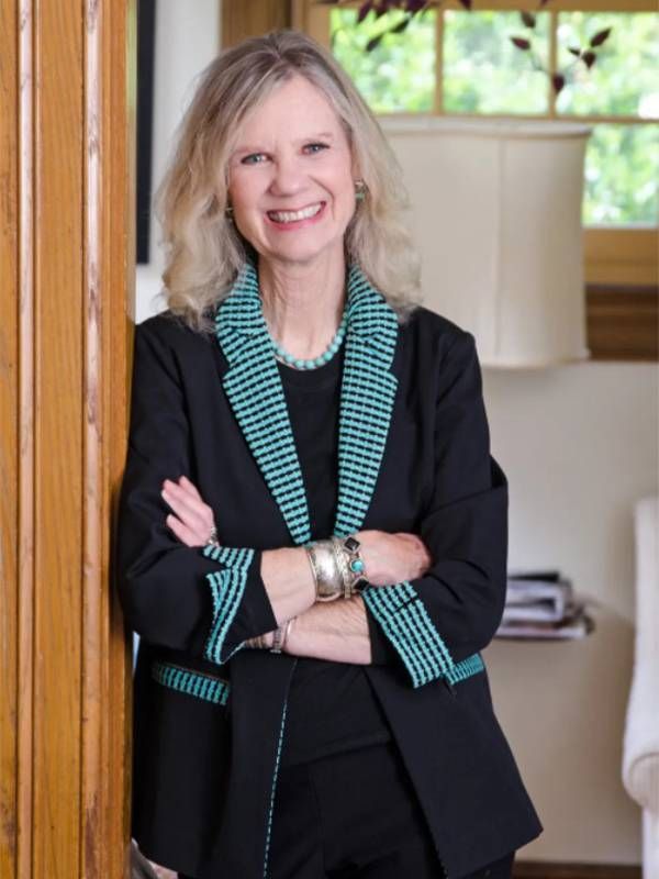 An older adult author standing in a doorway and smiling. Next Avenue, getting a job in your 50s