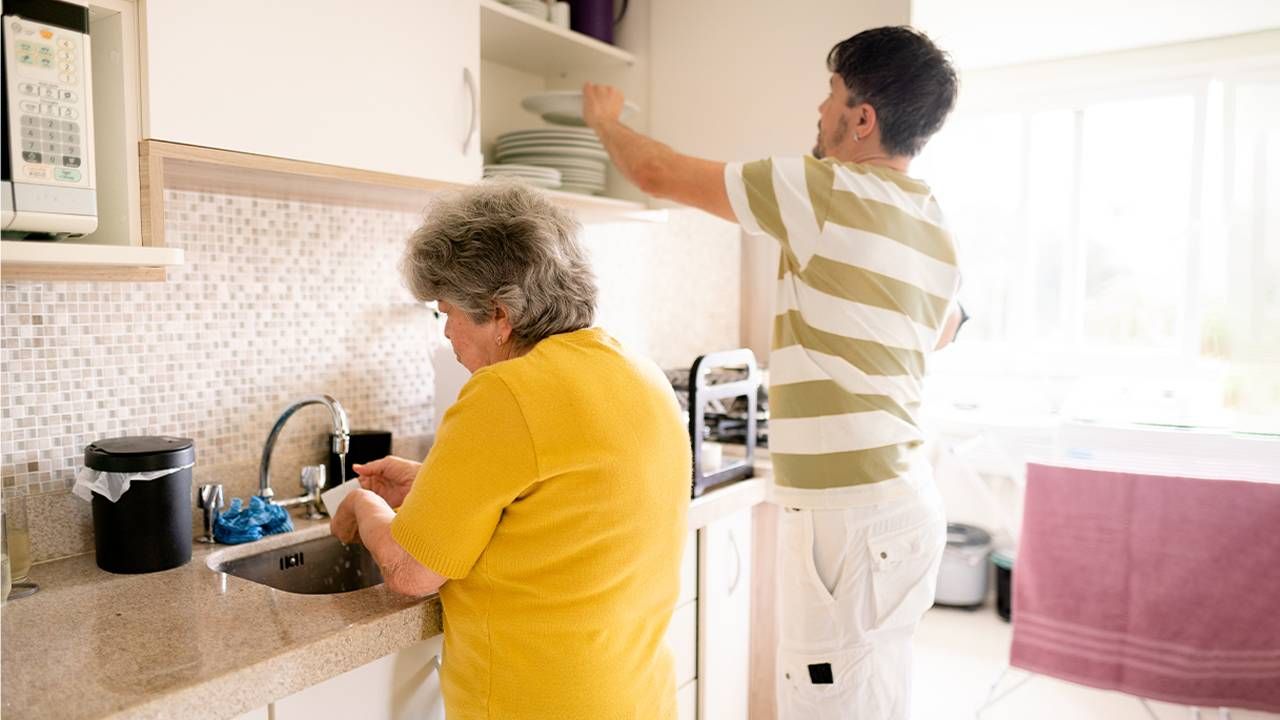 An older adult and their adult child doing spring cleaning around the house to make the home safer. Next Avenue