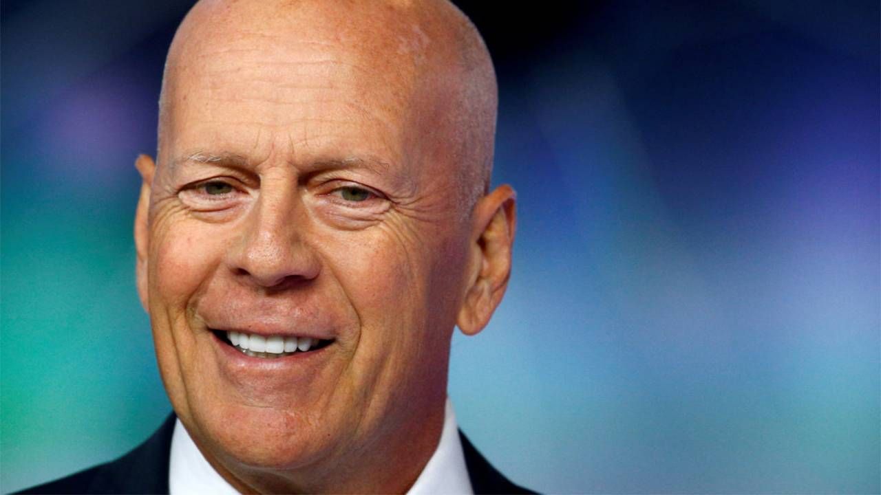 Actor Bruce Willis wearing a suit and tie. Next Avenue, aphasia