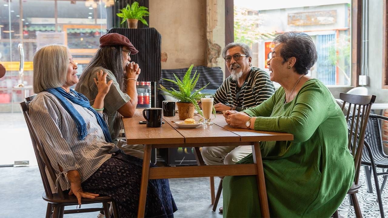 A group of older friends meeting at a coffee shop for a coffee group. Next Avenue, making friends in retirement, older adults making friends