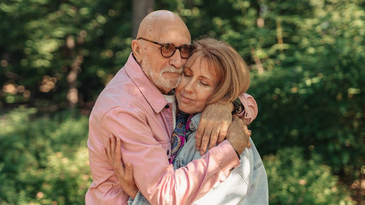 Two older adults embracing in a hug crying tears of joy. Next Avenue, Bittersweet, susan cain