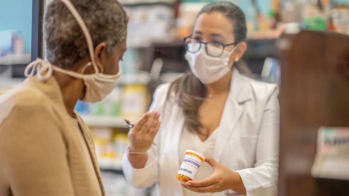 A pharmacist talking with a patient. Next Avenue, pharmacist, pharmacy