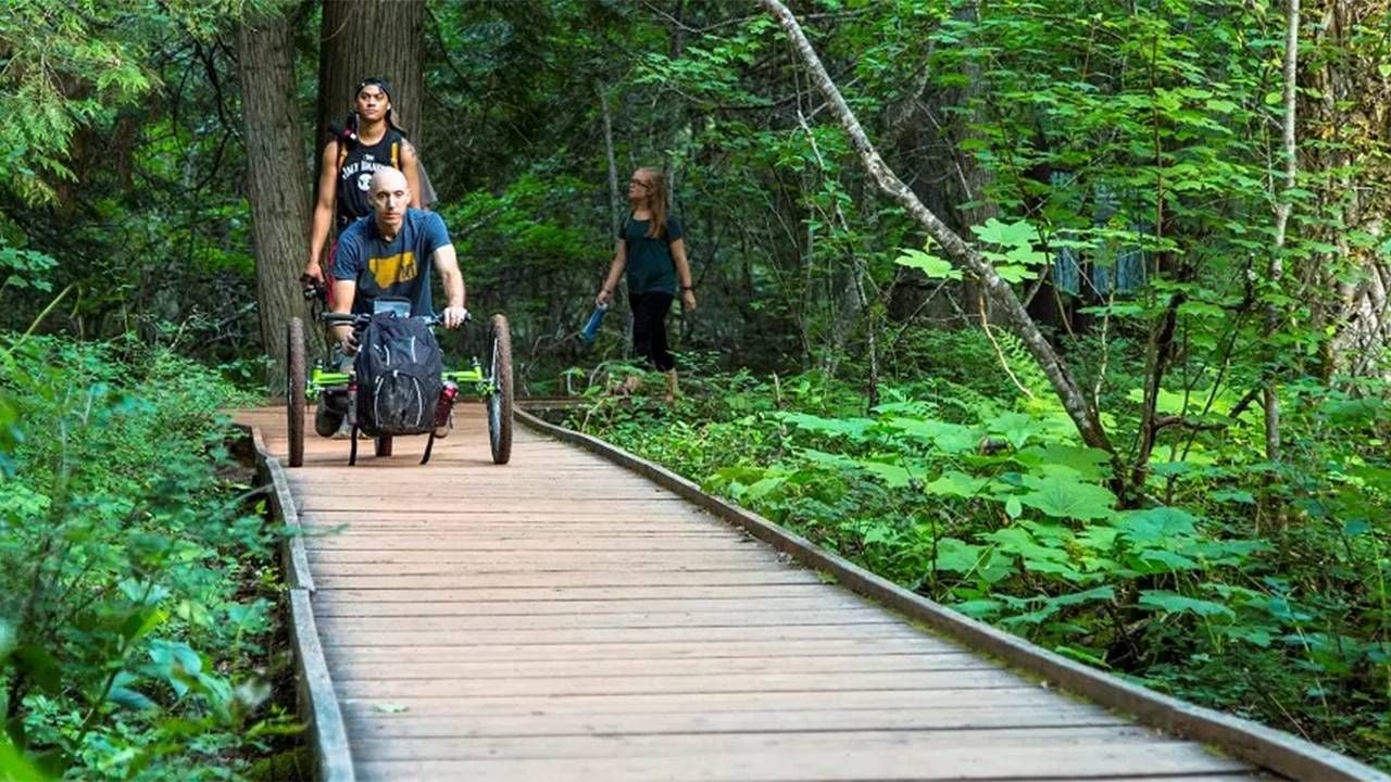 People using an accessible trail at Glacier National Park. Next Avenue, most accessible national parks, disability accessible wheelchair access